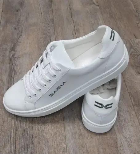 White leather Dacia sneakers with embossed logo - premium promotional footwear